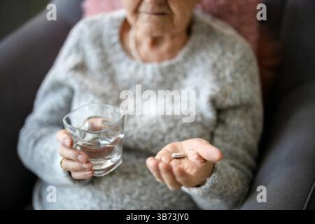 Senior woman taking her medication Stock Photo