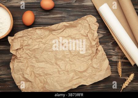 Prepare to baking. Dough ball near cookware on brown wooden background top view. Top view Stock Photo