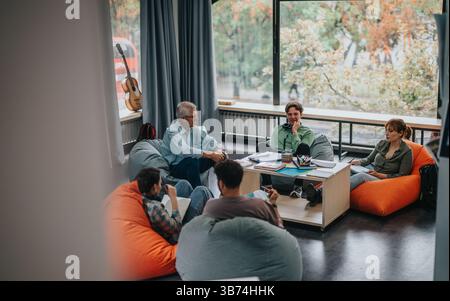 Professor engaging with students in a casual learning environment Stock Photo