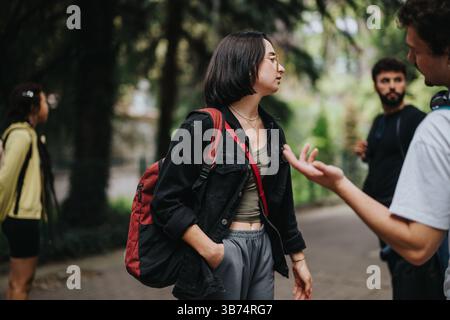Students and professor engaging in outdoor discussion on campus Stock Photo