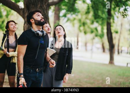 Young multicultural students collaborating on a school project in the park Stock Photo