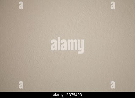 Textured beige plaster wall with swollen and cracked areas. Timeworn, rustic surface for design backgrounds Stock Photo