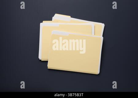 File folders with papers on dark background, top view Stock Photo