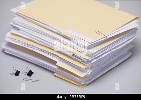 File folders with papers and binder clips on gray background, closeup Stock Photo
