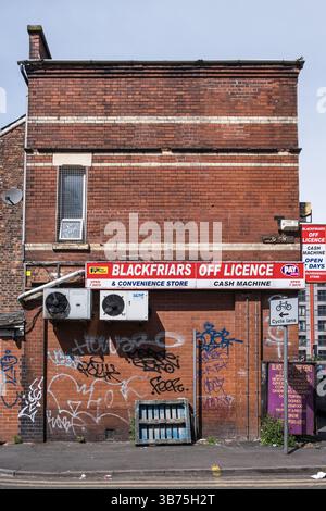 Side of red brick corner shop and off licence in Manchester, North England, UK. 2025 Stock Photo