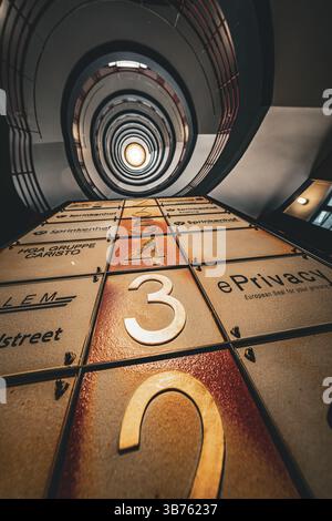 Spiral staircase with numbered elements and red banisters viewed from below, SPRINKENHOF, Hamburg, Germany, Europe Stock Photo