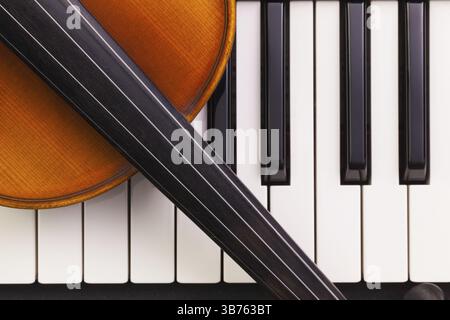 Very old violin lying on the piano Stock Photo