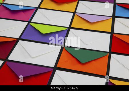 Composition with white and colored envelopes on the table. The photo suitable for various holidays and anniversaries Stock Photo