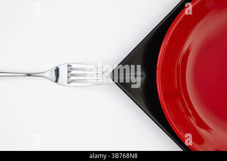 Different red and black plates on the white table.Top view. Flat Lay Image Stock Photo