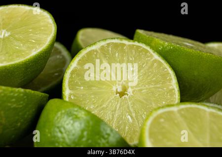 Close-Up of Green Citrus Lime Halves with Juicy Detail. Stock Photo