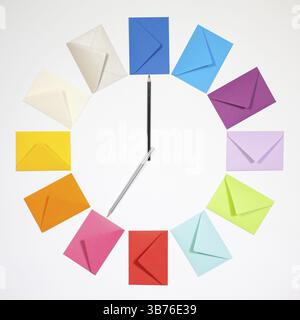 Twelve envelopes isolated on white background. Clock of colored envelopes for Christmas mailing Stock Photo
