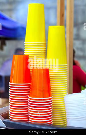 Stacks of colorful plastic cups on the table Stock Photo