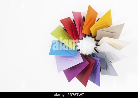 Propeller of colored envelopes on the white table Stock Photo