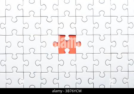 White Puzzle with Single Missing Piece Revealing orange Background Stock Photo