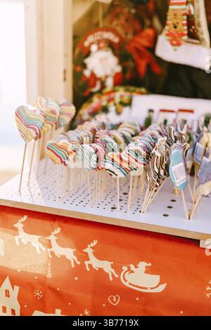 Showcase of the kiosk at the Christmas market - multicolored sucking candy lollipops. Stock Photo