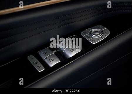 Car door inside close up with door handle and window control and adjustment button Stock Photo