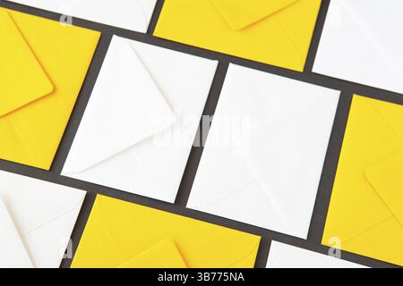 Composition with white and yellow, envelopes on the table. Different colored envelopes on the table Stock Photo