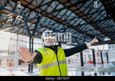 Engineer using virtual reality to inspect building progress. Stock Photo