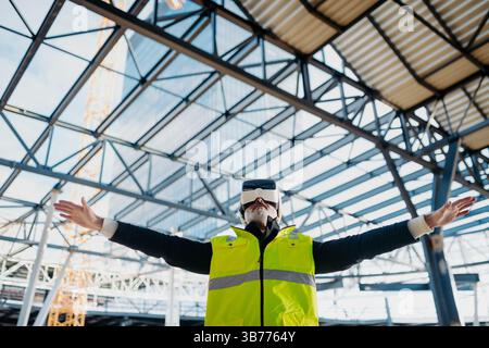 Engineer using virtual reality to inspect building progress. Stock Photo