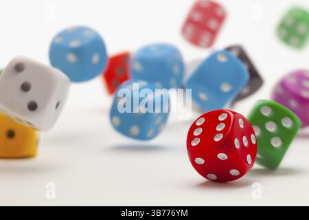 Playing dice at white wooden background. Playing a game with dice. Rolling the dice concept for business risk. Risk concept Stock Photo