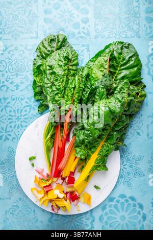 Fresh raw leaves of chard, leaf beets, mangold, swiss chard on kitchen table Stock Photo