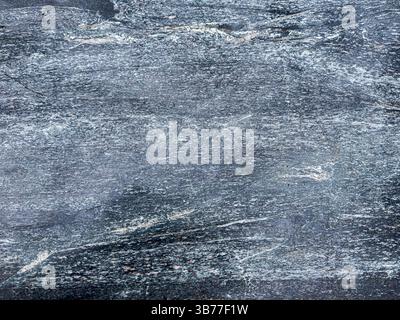 Textured blue-grey stone surface with natural mineral patterns and rough details. Stock Photo