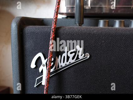 Itterbeck, Germany - Feb 4 2025 Detail of a Fender amplifier with a guitar cable. Fender Logo Stock Photo