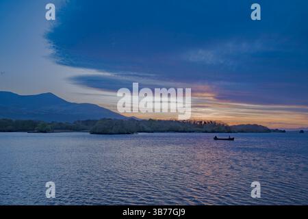 Boaters Taking in the Sunset at Lough Leane, Killarney National Park, Ireland Stock Photo