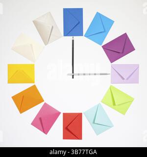 Twelve envelopes isolated on white background. Clock of colored envelopes for Christmas mailing Stock Photo