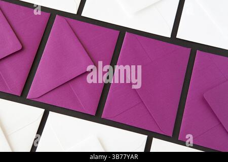 Composition with white and purple envelopes on the table. Different colored envelopes on the table Stock Photo