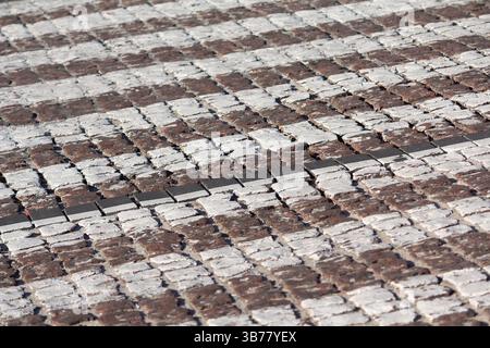 Cobblestone with white stripes of ground transition. Backgrounds Stock Photo
