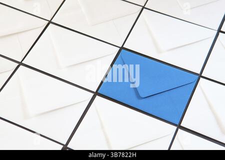 Composition with white and blue envelopes on the table. Different colored envelopes on the table Stock Photo