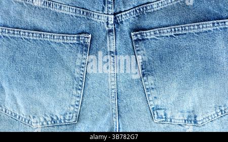 Jeans textile texture background,denim back side pockets backdrop,empty copy space.Blue canvas. Stock Photo