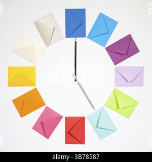Twelve envelopes isolated on white background. Clock of colored envelopes for Christmas mailing Stock Photo