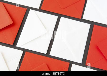 Composition with white and red envelopes on the table. Different colored envelopes on the table Stock Photo