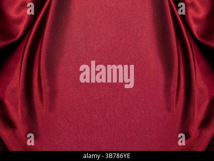 Red silk elegant background, Valentine's day backdrop. Satin fabric empty copy space, theatre design,royal texture,elegant wave curtain. Stock Photo