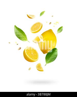 Juicy flying yellow lemons, green leaves isolated on white background. Creative food design.  Lemon fruit slices composition. Summer refreshment, obje Stock Photo