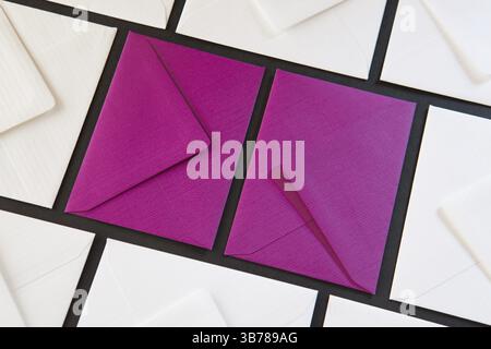 Composition with white and purple envelopes on the table. Different colored envelopes on the table Stock Photo