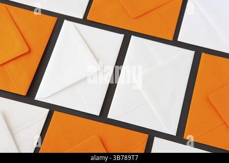 Composition with white and orange envelopes on the table. Different colored envelopes on the table Stock Photo