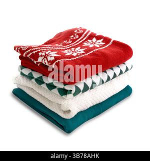 Stack of folded sweaters on white background.Christmas knitted clothes stack. Stock Photo