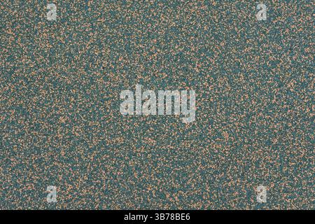 Yellow and green sports field rubber coating close up macro view. Playground paving background texture extremely close. Stock Photo