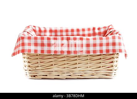Empty straw basket with checkered red  linen isolated. Stock Photo
