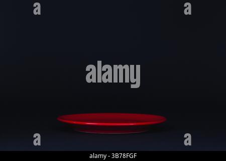 Empty red plate on the black background Stock Photo