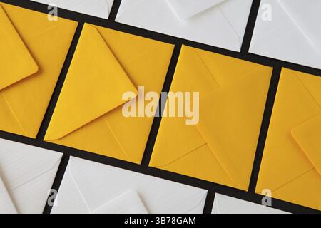 Composition with white and yellow, envelopes on the table. Different colored envelopes on the table Stock Photo