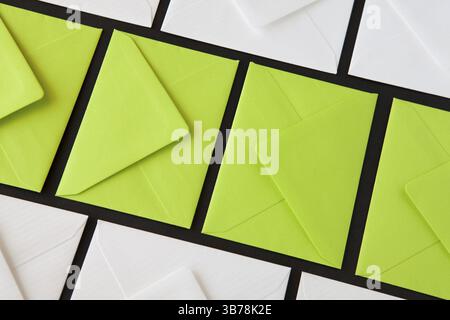 Composition with white and green envelopes on the table. Different colored envelopes on the table Stock Photo