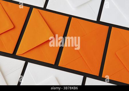 Composition with white and orange envelopes on the table. Different colored envelopes on the table Stock Photo