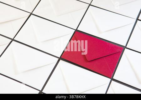 Composition with white and red envelopes on the table. Different colored envelopes on the table Stock Photo