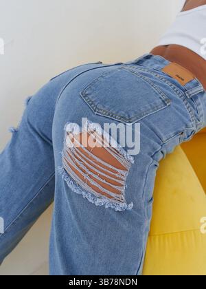 Close-up of ripped blue denim jeans Stock Photo