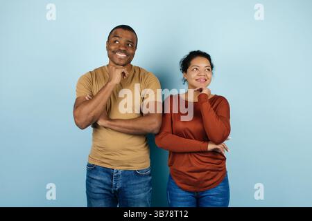 Pensive Black Man And Woman Thinking About Something And Looking Away Stock Photo