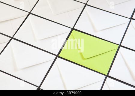Composition with white and green envelopes on the table. Different colored envelopes on the table Stock Photo